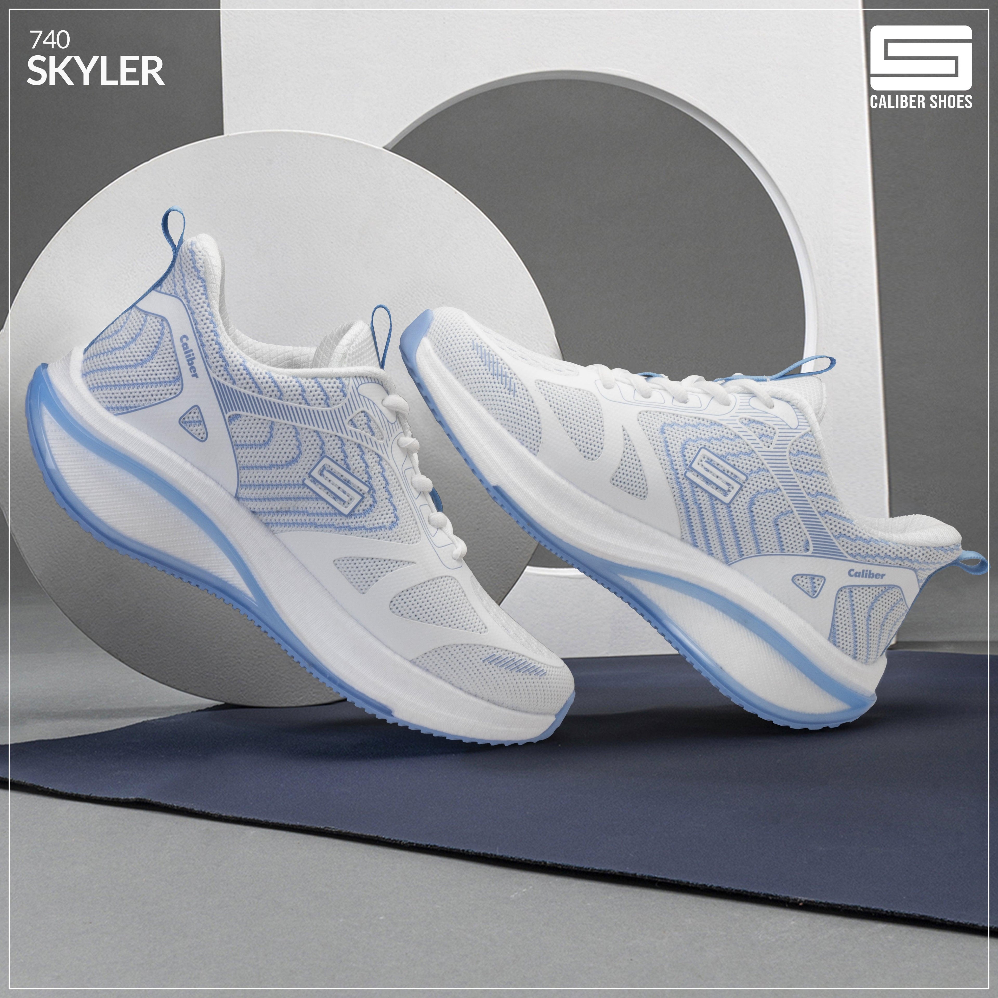 Men's sports shoes in white and blue from Caliber Shoes, model Skyler, showcased on a minimalistic background.