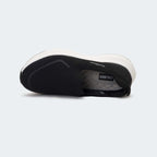 Caliber Shoes black knit slip-on sneakers with white EVA bubble sole and grey logo detail.
