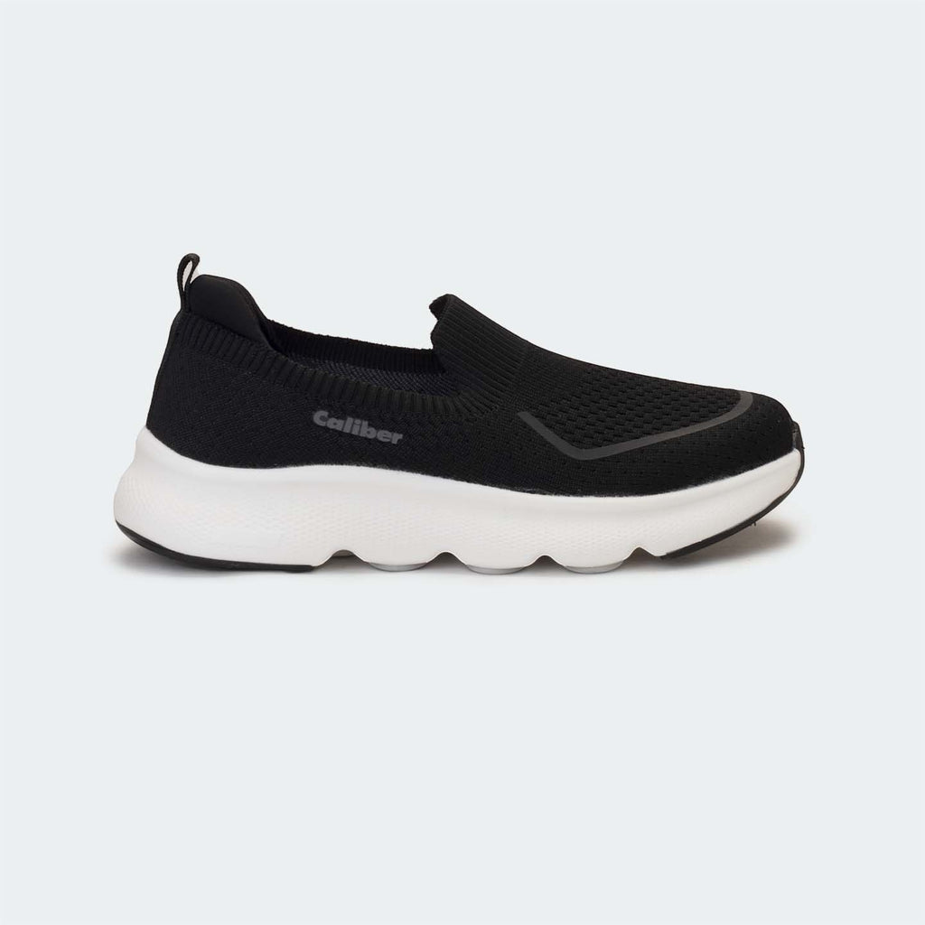 Caliber Shoes black knit slip-on sneakers with white EVA bubble sole and grey logo detail.