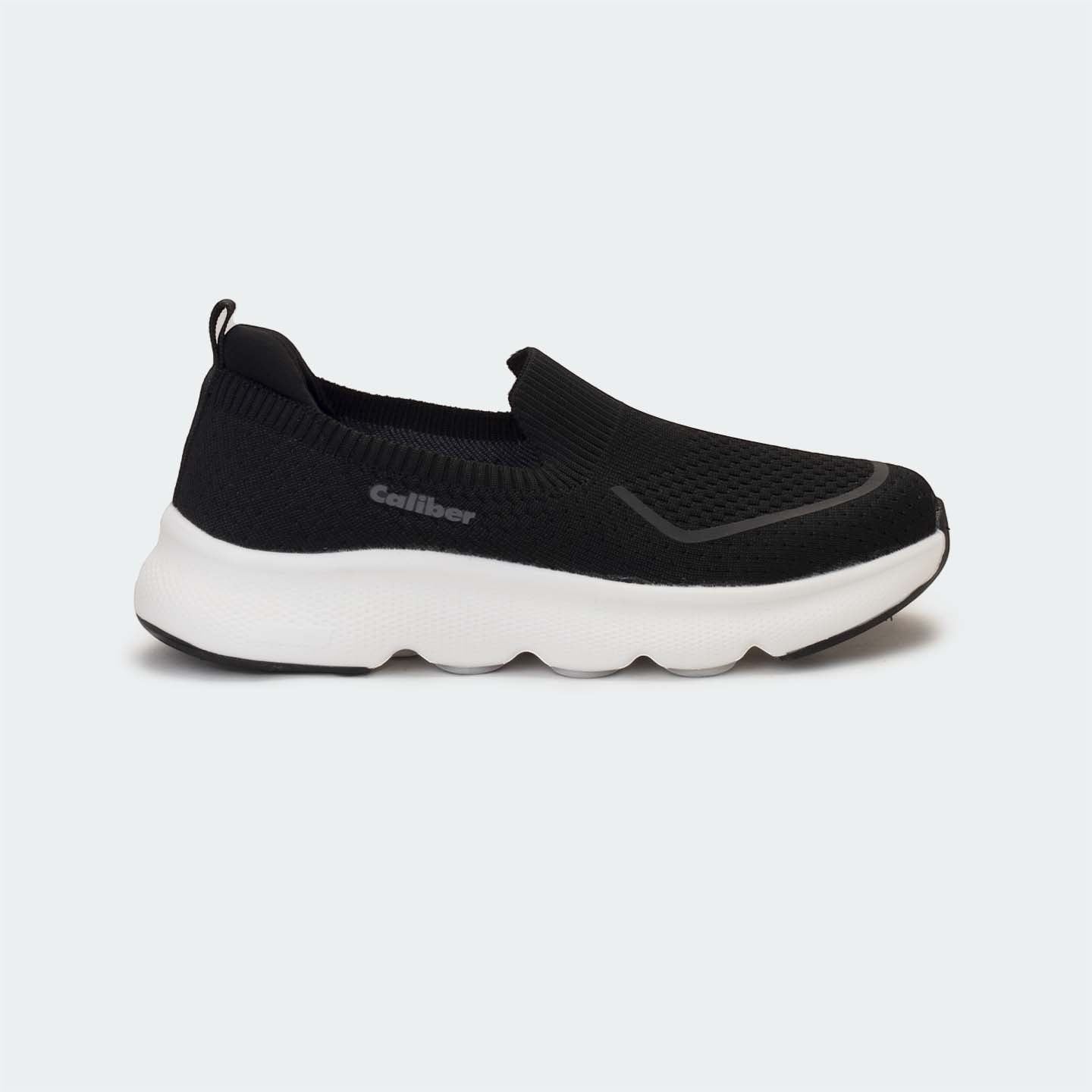 Caliber Shoes black knit slip-on sneakers with white EVA bubble sole and grey logo detail.