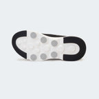 Caliber Shoes black knit slip-on sneakers with white EVA bubble sole and grey logo detail.