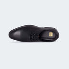 Caliber Shoes black faux leather plain toe derby dress shoes with lace-up closure and pebbled texture.